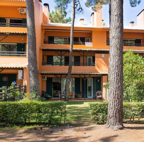 an orange building with trees in front of it at Aroeira - Nature, Beach & Golf, by TimeCooler in Almada