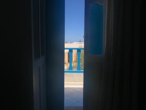 an open door with a view of a pool at Family Home in Midoun