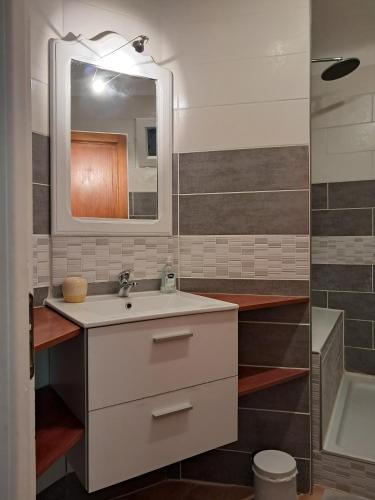 une salle de bain avec un lavabo et un miroir dans l'établissement Chez Marie, à Carry-le-Rouet