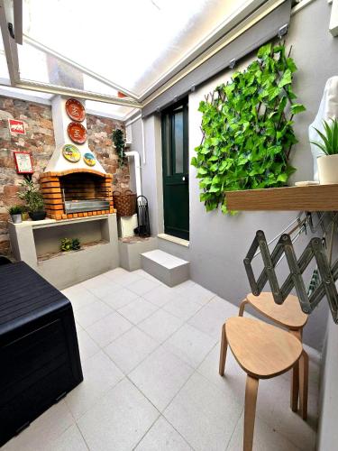a patio with a pizza oven and a chair at Zen House Casa de Aldeia in Santo António da Terrugem