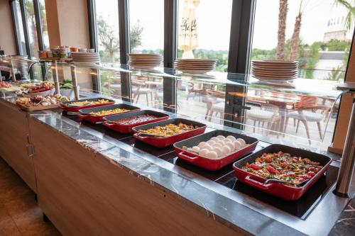 a buffet line with many dishes of food on it at Hayat Sky Hotel Rust in Rust