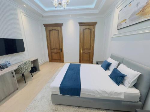 a large bedroom with a bed and a television at Turon City Hotel in Samarkand