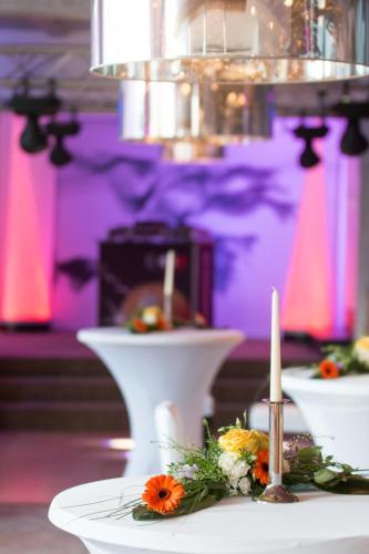 a table with two white plates with flowers on it at Romantikhotel Platte in Attendorn