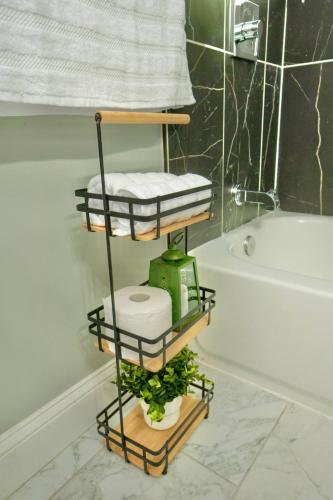 a bathroom with a shelf with towels and a toilet at Spacious 3BR Near NYC with Workspace in Newark