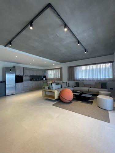 a living room with a couch and a table at 3 Olive Trees in Anavissos