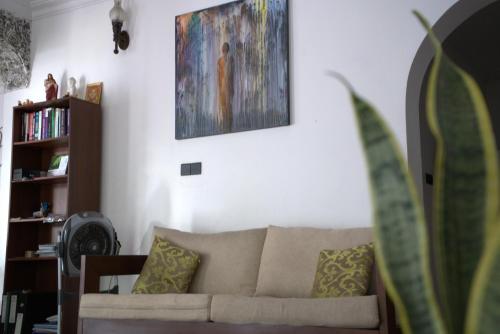 a living room with a couch and a painting on the wall at Murphy's Transit Villa Airport Pick & Drop Katunayake in Katunayake