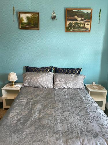 a blue bedroom with a bed with two night stands at House 220 in London