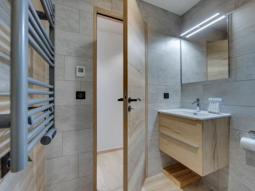 une salle de bain avec un lavabo et un miroir dans l'établissement Appartement Duplex Ski-In/Ski-Out avec Piscine, Jacuzzi et Espace Bien-être - FR-1-686-34, à Arc 1950