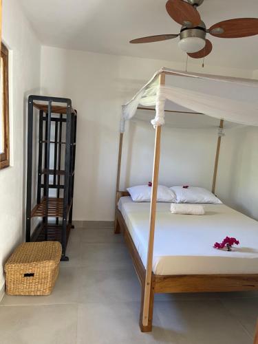 a bedroom with a bunk bed and a fan at Le petit relais 2 in Nosy Be