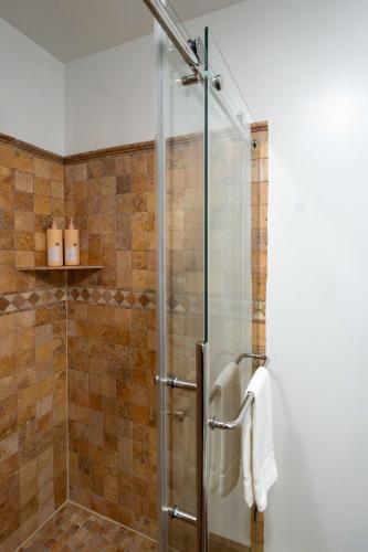 a shower with a glass door in a bathroom at Beechmont-Charming Colonial for Events and Getaways! in Bridgeport