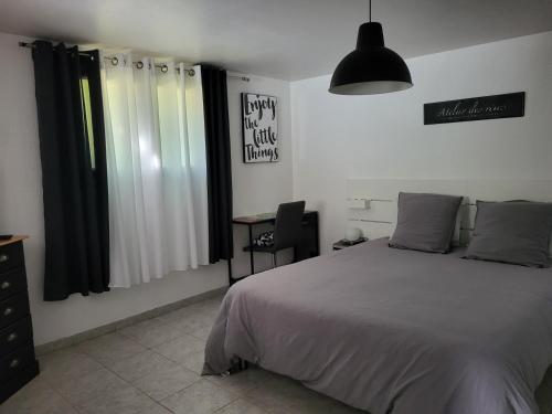 a bedroom with a bed and a desk in it at Location gîte dans le var in Le Thoronet
