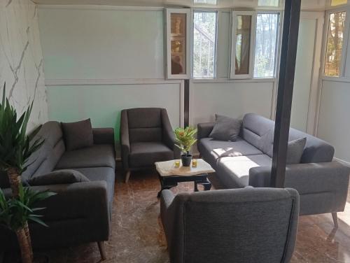 a living room with two couches and a table at Nino's House Ureki in Ureki