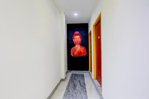 a hallway with a painting of a woman on the door at OYO Annapurna Restaurant & Hotel in Patna
