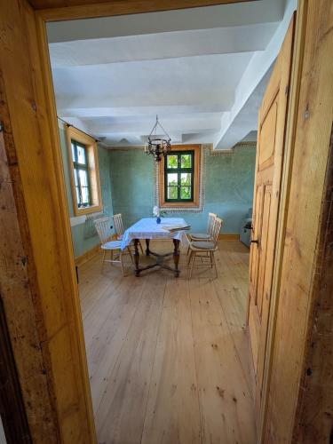 a dining room with a table and chairs at Historisches Forsthaus Wachstedt in Wachstedt