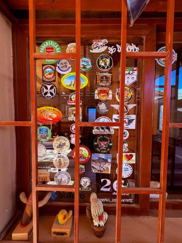 a display case with a bunch of plates on it at Hostal Hara in San Pedro de Atacama