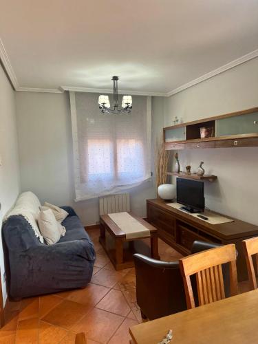 a living room with a couch and a desk at La Capellanía in Canalejas de Peñafiel