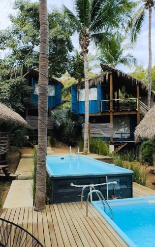 a resort with a swimming pool and a house at H20 Hotel Container in San Agustinillo