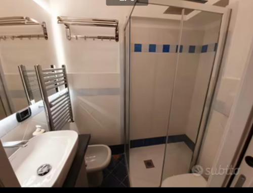 a bathroom with a shower and a toilet and a sink at La casa a chiocciola in Albisola Superiore