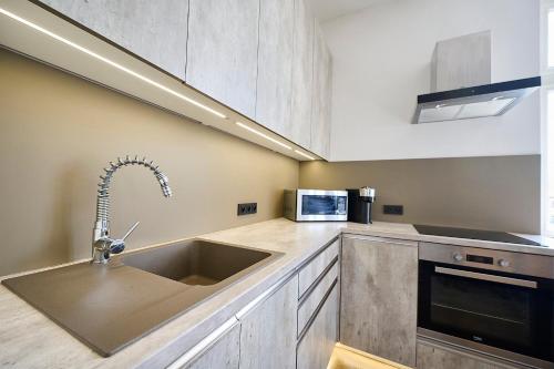 a kitchen with a sink and a microwave at Apartmán Mariánská-centrum in Liberec