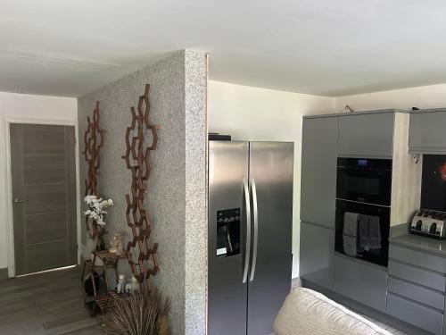a kitchen with a stainless steel refrigerator at The Quarry Woolton Village in Childwall