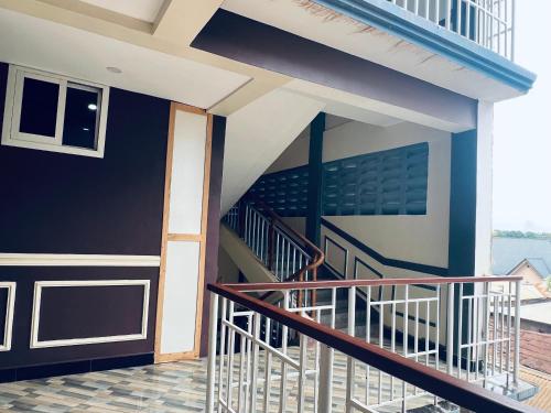 a staircase in a house with a balcony at Elly Villa Hotel in Moshi