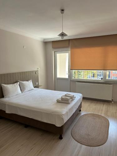 a bedroom with a large bed and a large window at Well Hotel Edirne in Edirne
