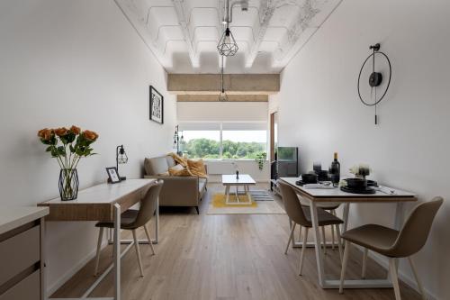 a kitchen and living room with a table and chairs at 1BR Ideal for Workers at MK Central Train Station with Free Parking and Fast Wi-Fi in Milton Keynes