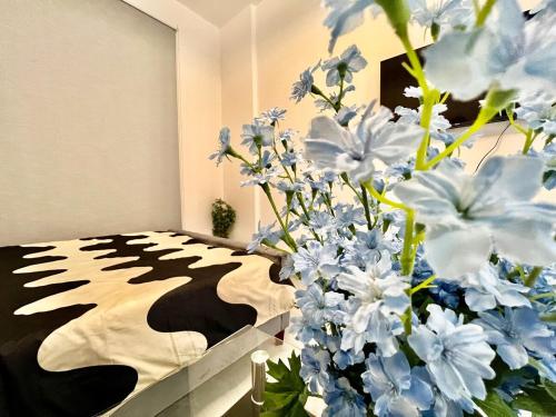 a room with a bed with blue and white flowers at 3 mins walk to ADCB metro in Dubai