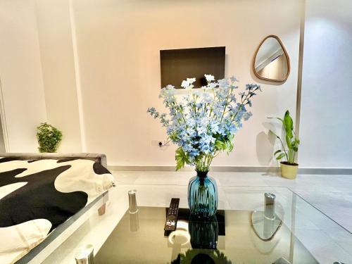 a room with a vase of flowers on a glass table at 3 mins walk to ADCB metro in Dubai
