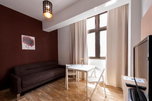 a living room with a couch and a table at Las Palmas Urban Center in Las Palmas de Gran Canaria