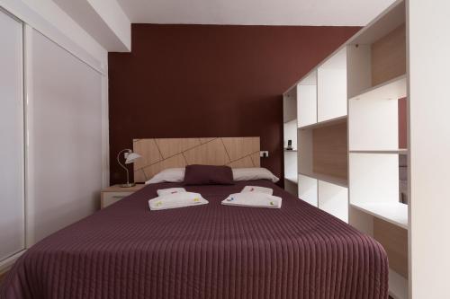 a bedroom with a bed with two towels on it at Las Palmas Urban Center in Las Palmas de Gran Canaria