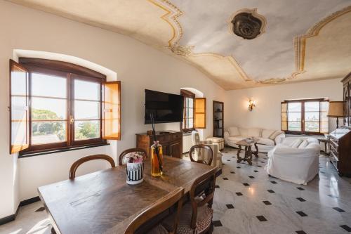 a living room with a table and a couch at Villa with Pool - Unique Sea View - Free Parking in Zoagli