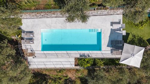 an overhead view of a swimming pool with umbrellas at Villa with Pool - Unique Sea View - Free Parking in Zoagli
