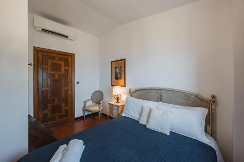 a bedroom with a blue bed with white pillows at Villa with Pool - Unique Sea View - Free Parking in Zoagli