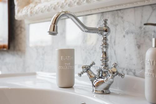 a bathroom sink with a faucet and a cup at Villa with Pool - Unique Sea View - Free Parking in Zoagli