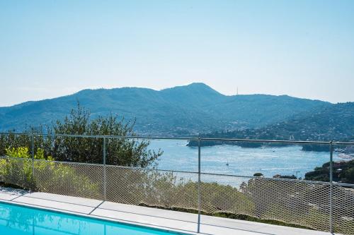 a swimming pool with a view of a body of water at Villa with Pool - Unique Sea View - Free Parking in Zoagli