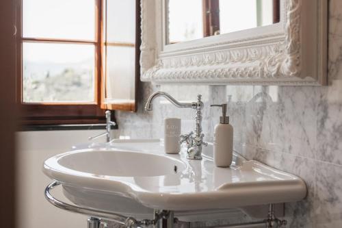 a bathroom with a white sink and a mirror at Villa with Pool - Unique Sea View - Free Parking in Zoagli