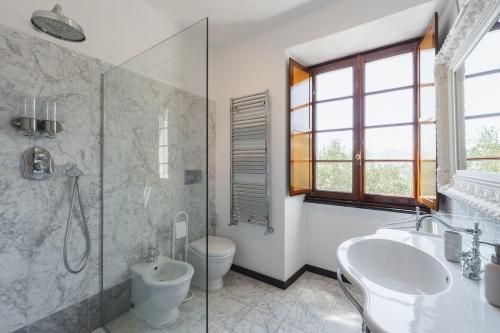 a bathroom with a toilet and a sink and a shower at Villa with Pool - Unique Sea View - Free Parking in Zoagli