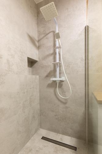 a shower with a shower head in a bathroom at Apartament Deluxe Chełm in Chełm