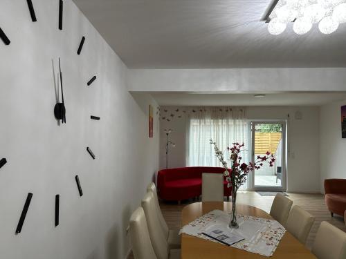 a living room with a table and a red couch at Luxury rooms in a new House in Ilsfeld