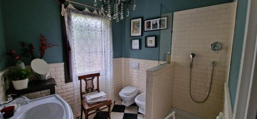 a bathroom with a shower and a toilet and a sink at A Casa dalla Ross in Marzabotto