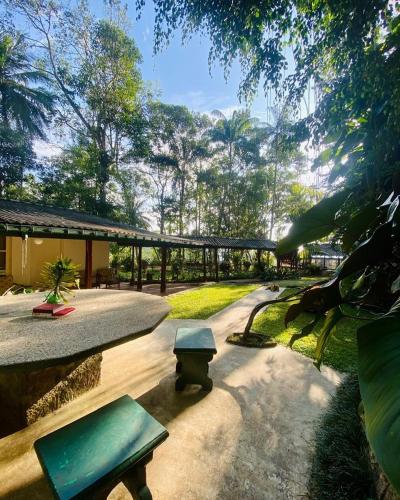 a park with benches and a building and trees at Crystal Villa Knuckles in Kandy