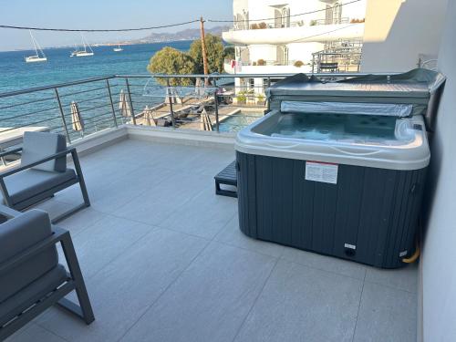 a trash can sitting on a balcony next to the water at La vie luxury suites in Megalochori
