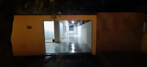 a dark room with a hallway with a door open at Casa Recanto do aconchego - Ao lado do centro in Bom Jesus da Lapa