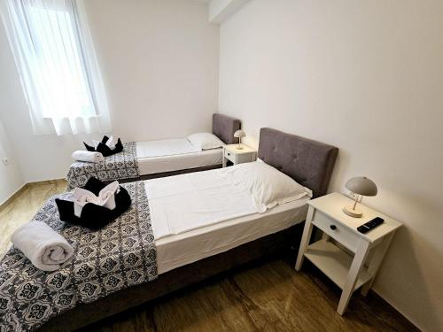 a small bedroom with a bed and a table at Villa Green s bazenom in Medulin