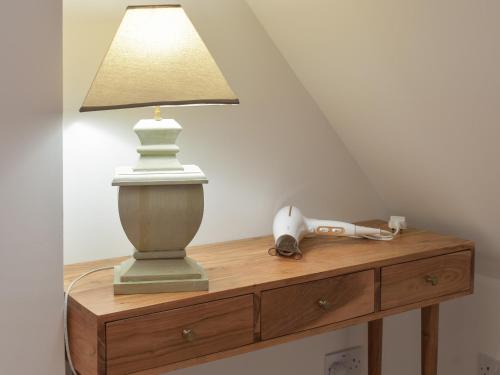 a lamp on top of a wooden dresser at Whitehouse Studio in Roslin