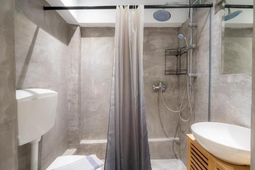 a bathroom with a shower and a toilet and a sink at Rethymno Dome Garden in Rethymno