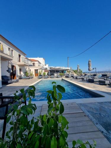 a swimming pool with a view of the ocean at La vie luxury suites in Megalochori
