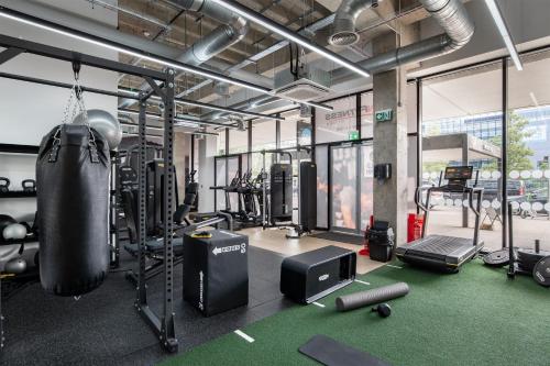 a gym with a punching bag and lots of equipment at 1BR Ideal for Workers at MK Central Train Station with Free Parking and Fast Wi-Fi in Milton Keynes