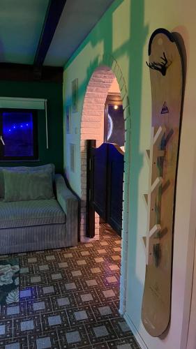 a room with an archway with a snowboard on the wall at Avaluna 6 osobe max - shower outside tus spolja in Vrčin